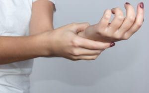 Woman Holding Numb Hand